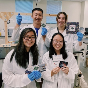 Four students posing together in the lab.
