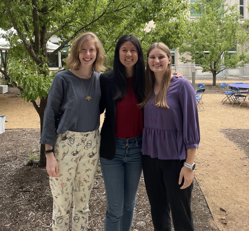 Three students standing together.