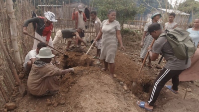 People digging to create a garden.