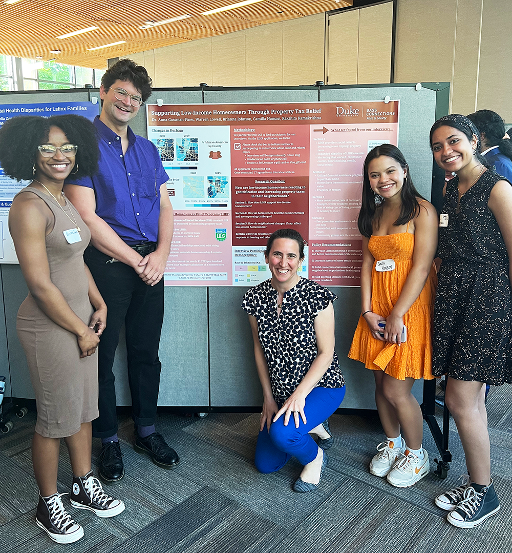 Young adults standing in front of an academic poster display.