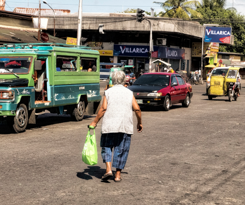 Image: Crossing: Elderly lady making her way across the road. Bacolod City, Philippines, by Brian Evans