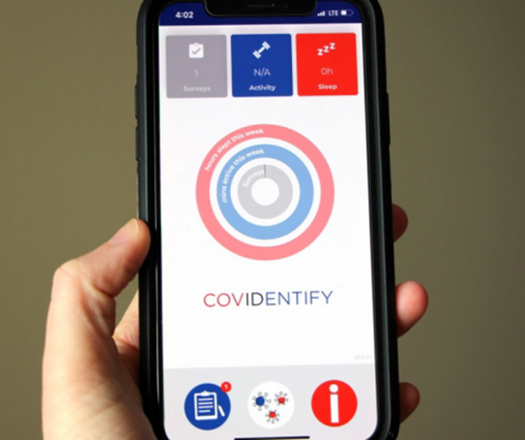 Closeup of adult hand holding smartphone showing screenshot of Covidentify app