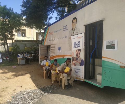 People outside a mobile health clinic.