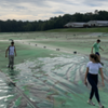Students on a covered waste lagoon.
