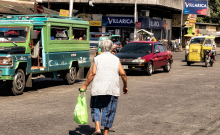Image: Crossing: Elderly lady making her way across the road. Bacolod City, Philippines, by Brian Evans