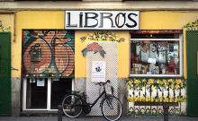 Exterior of a bookstore with sign: Libros.