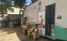 People outside a mobile health clinic.