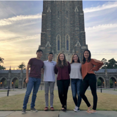 Four team members standing in front of Duke Chapel.