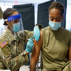 Airman 1st Class Trinity Packer joins members of the North Carolina National Guard receiving COVID-19 inoculations.