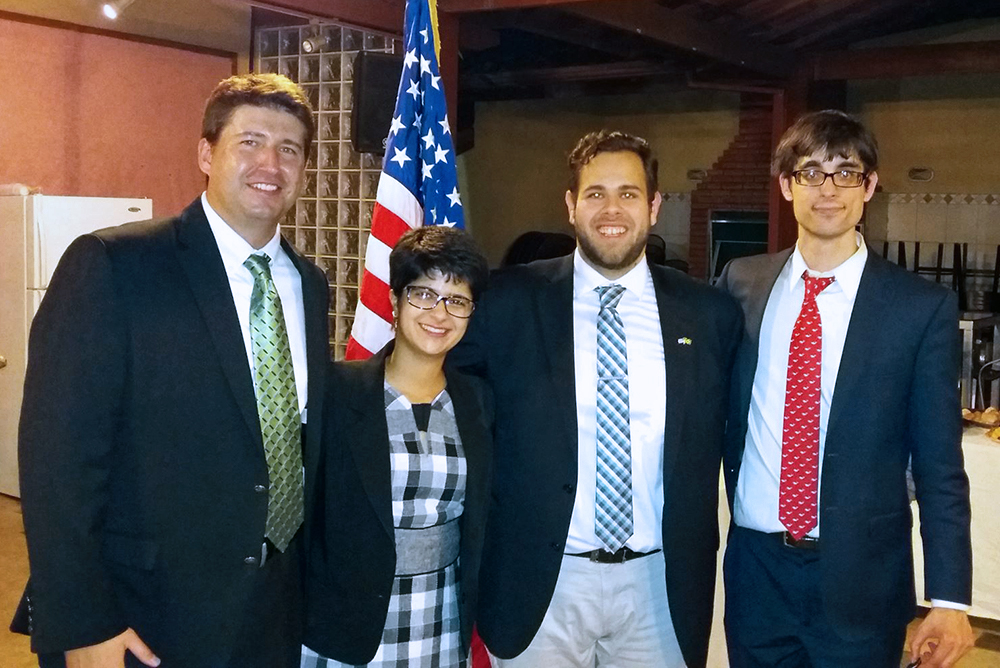 Travis Knoll at right, with other interns at an Embassy-sponsored party