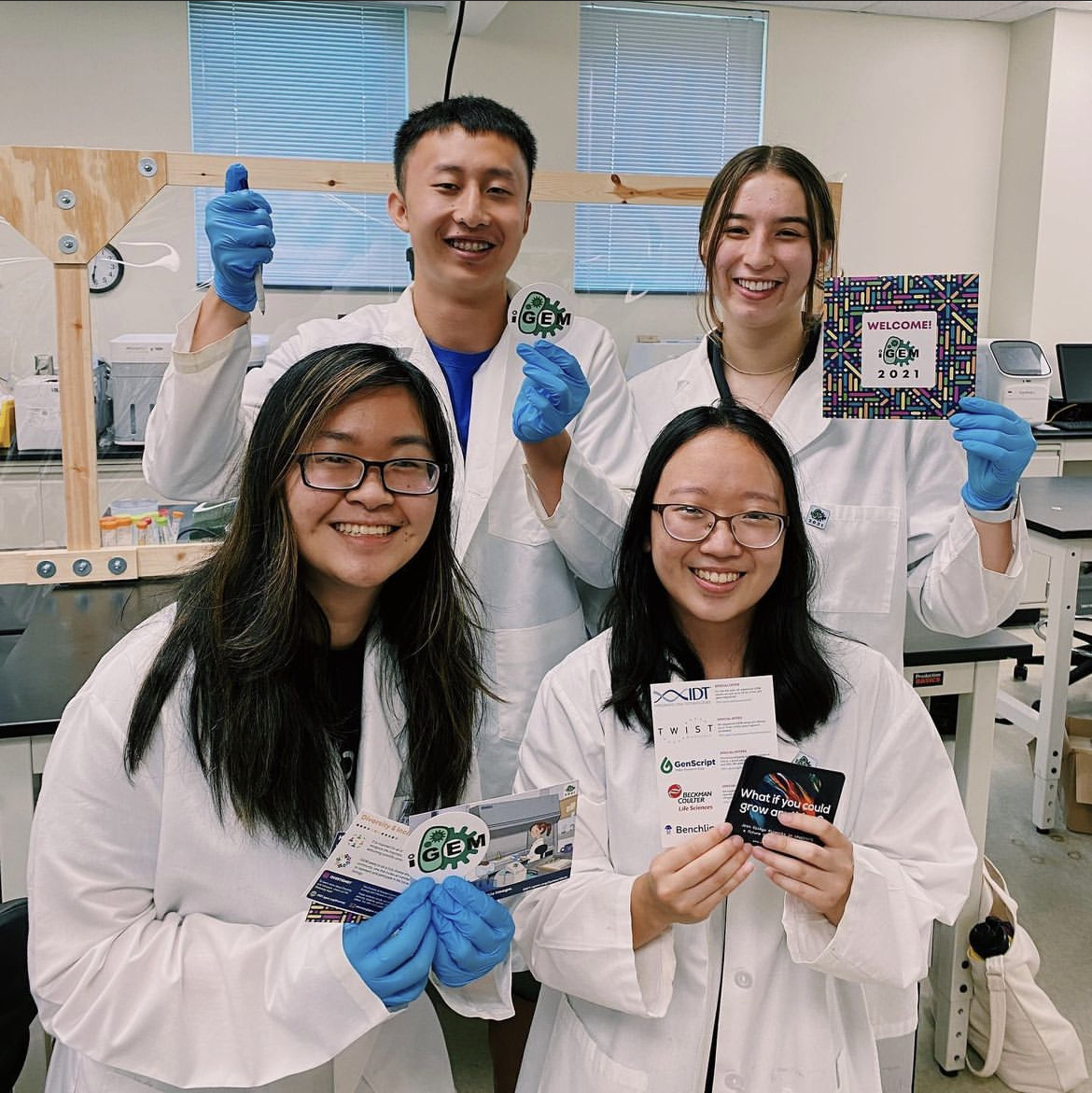 Four students posing together in the lab.