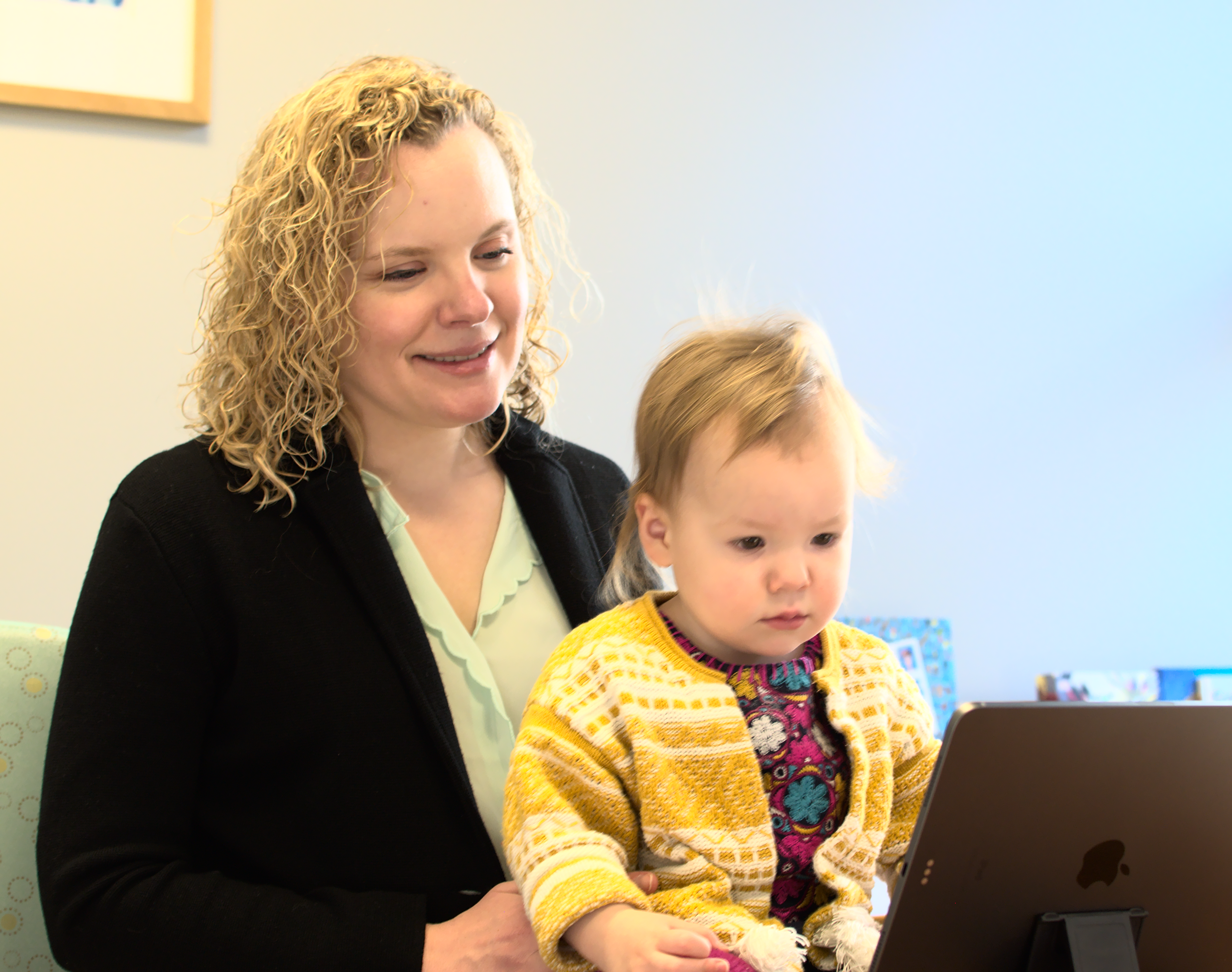 Child and caregiver with iPad.