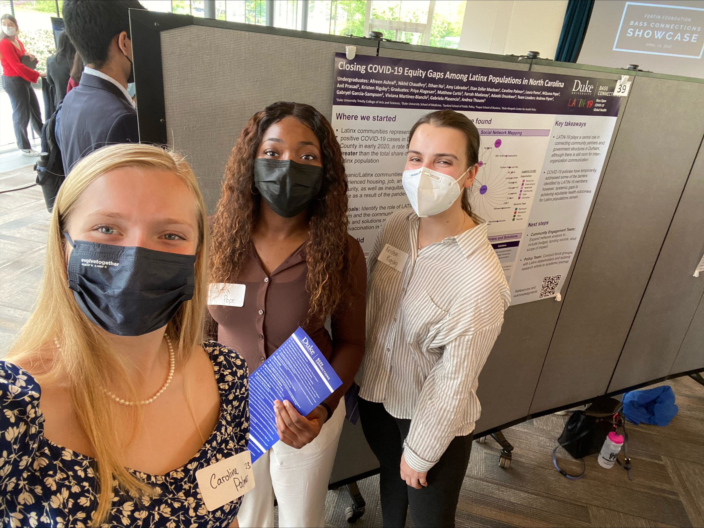 Three students standing in front of their research poster.