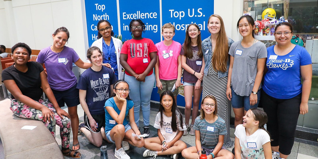 Bass Connections team with local girls during math workshop.