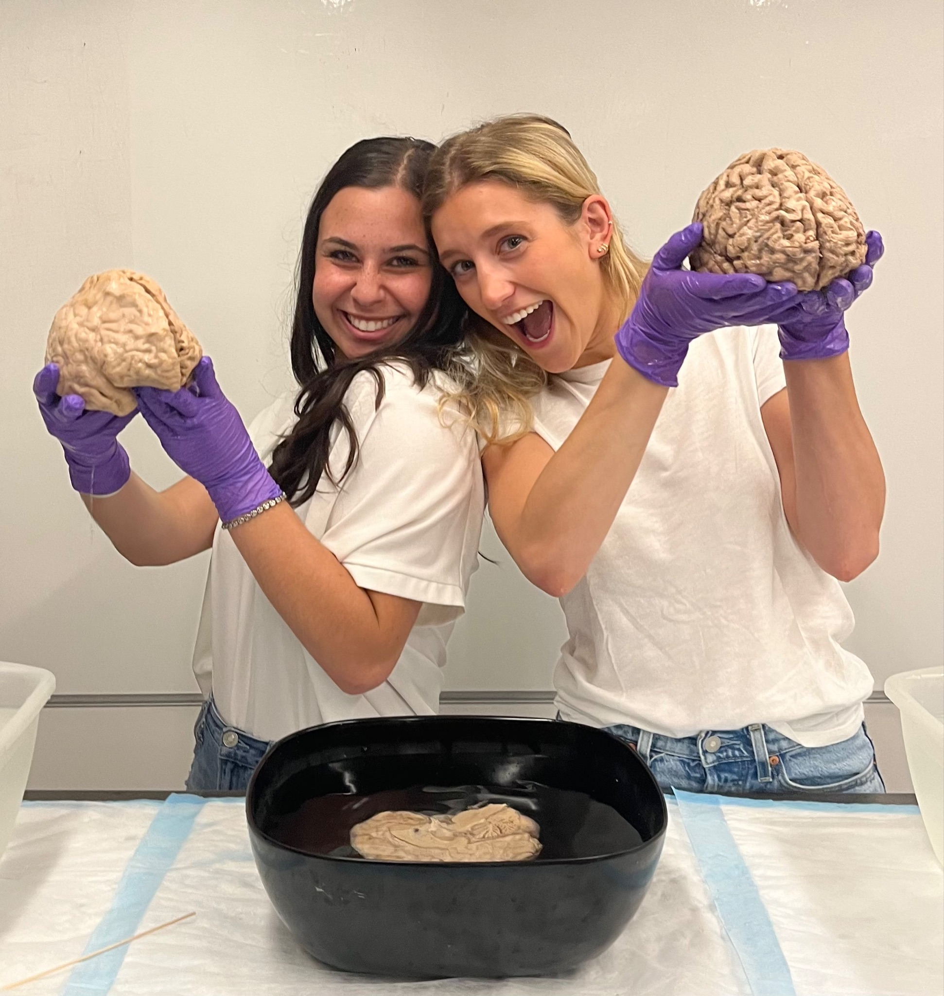 Two students holding brains.