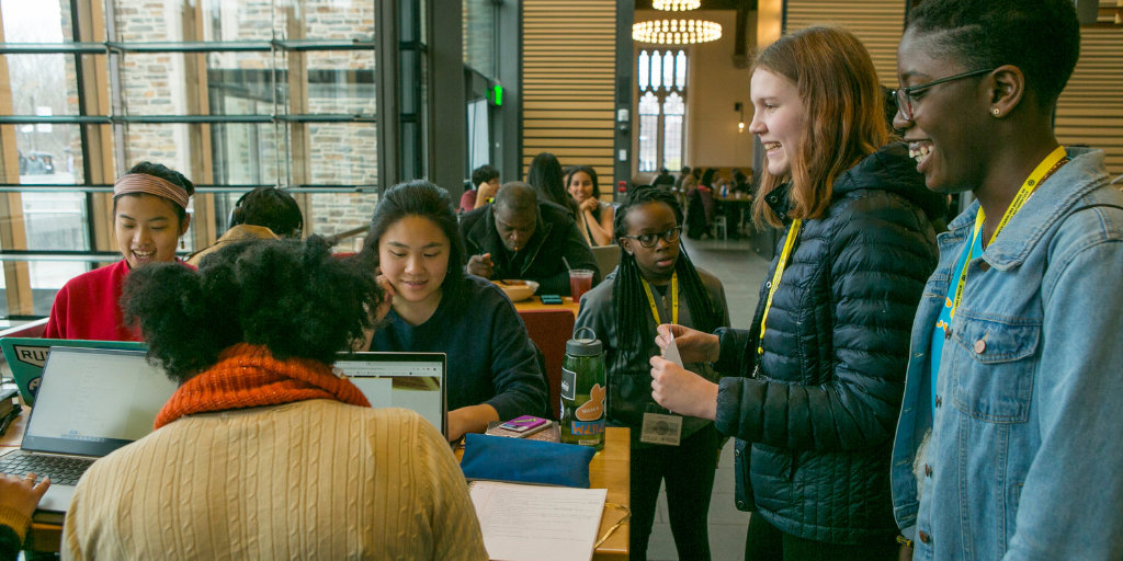 Duke students Joyce Zhao and Karissa Tu fill out a survey conducted by Gugu Malinga, 14, Hayes Hunter, 14, and Arianna Dwomoh, 16, in the Brodhead Center during Day of Data. Credit: Jared Lazarus.