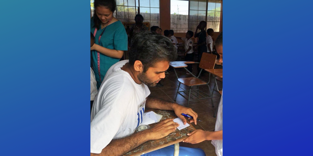 Hemal collecting demographic information from children in a school in French Harbor, Roatán.