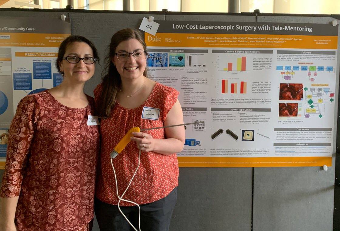 Tamara Fitzgerald and Jenna Mueller pose in front of their prize-winning (People's Choice) poster about their project, Low-Cost Laparoscopic Surgery with Tele-Monitoring