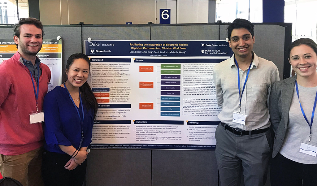 Sean Bissell, Michelle Wong, Sahil Sandhu and Zoe King present their poster, “Facilitating the Integration of Electronic Patient Reported Outcomes into Clinician Workflows,” at the Visible Thinking Undergraduate Research Symposium, April 2019. (Photo: Duke Service-Learning)