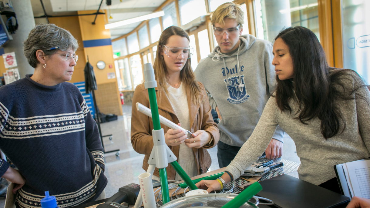 Faculty and students work on engineering design projects.