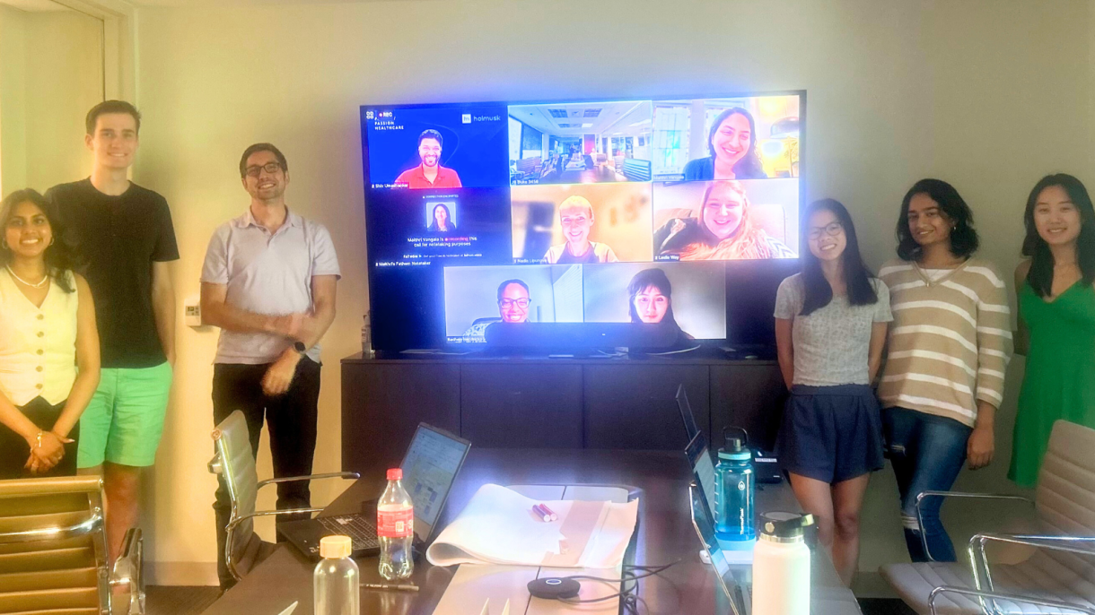 Team members meet with company Holmusk via video conference.