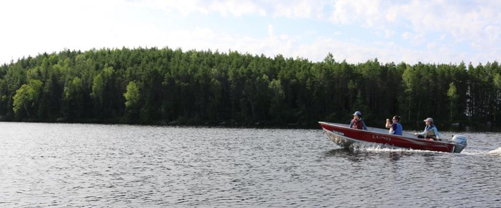 Team members Karen Jin, Kateri Salk, and Kim Bourne travel across Lake 239 to visit long-term monitoring sites.