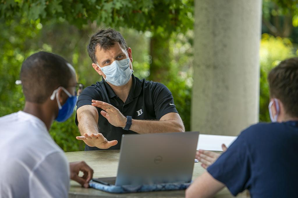 Jason Luck with two students.