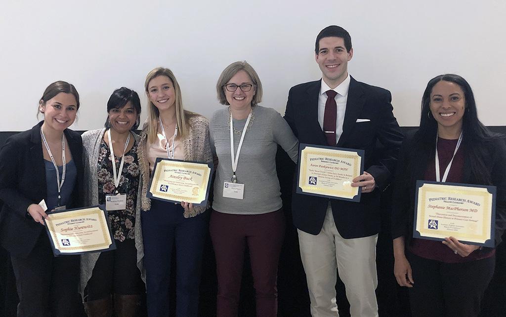 Team members holding awards.